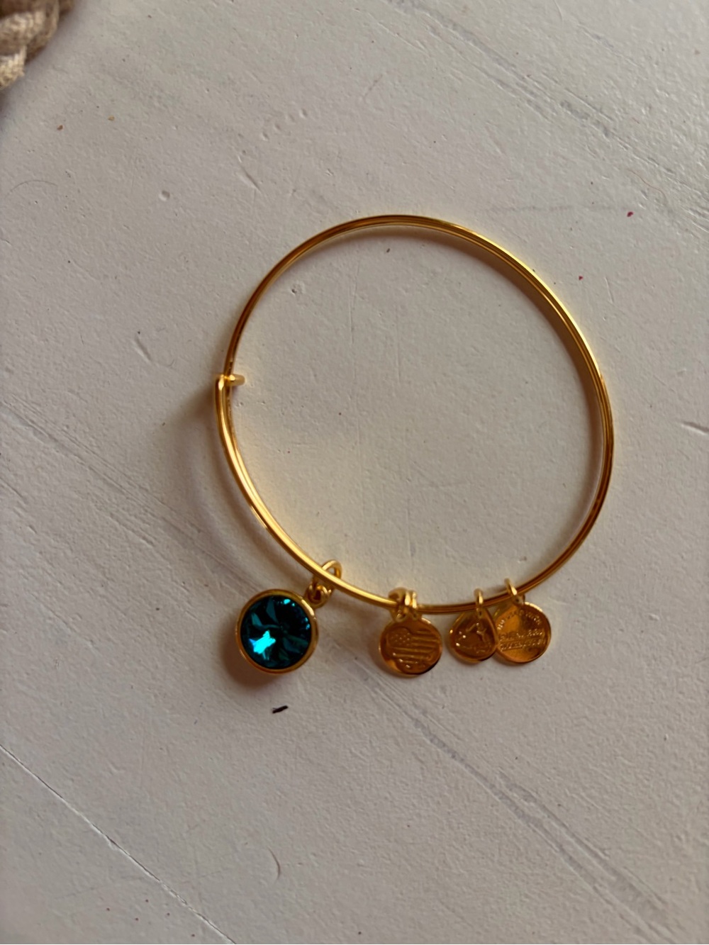 Alex and Ani adjustable gold bracelet with blue crystal charm